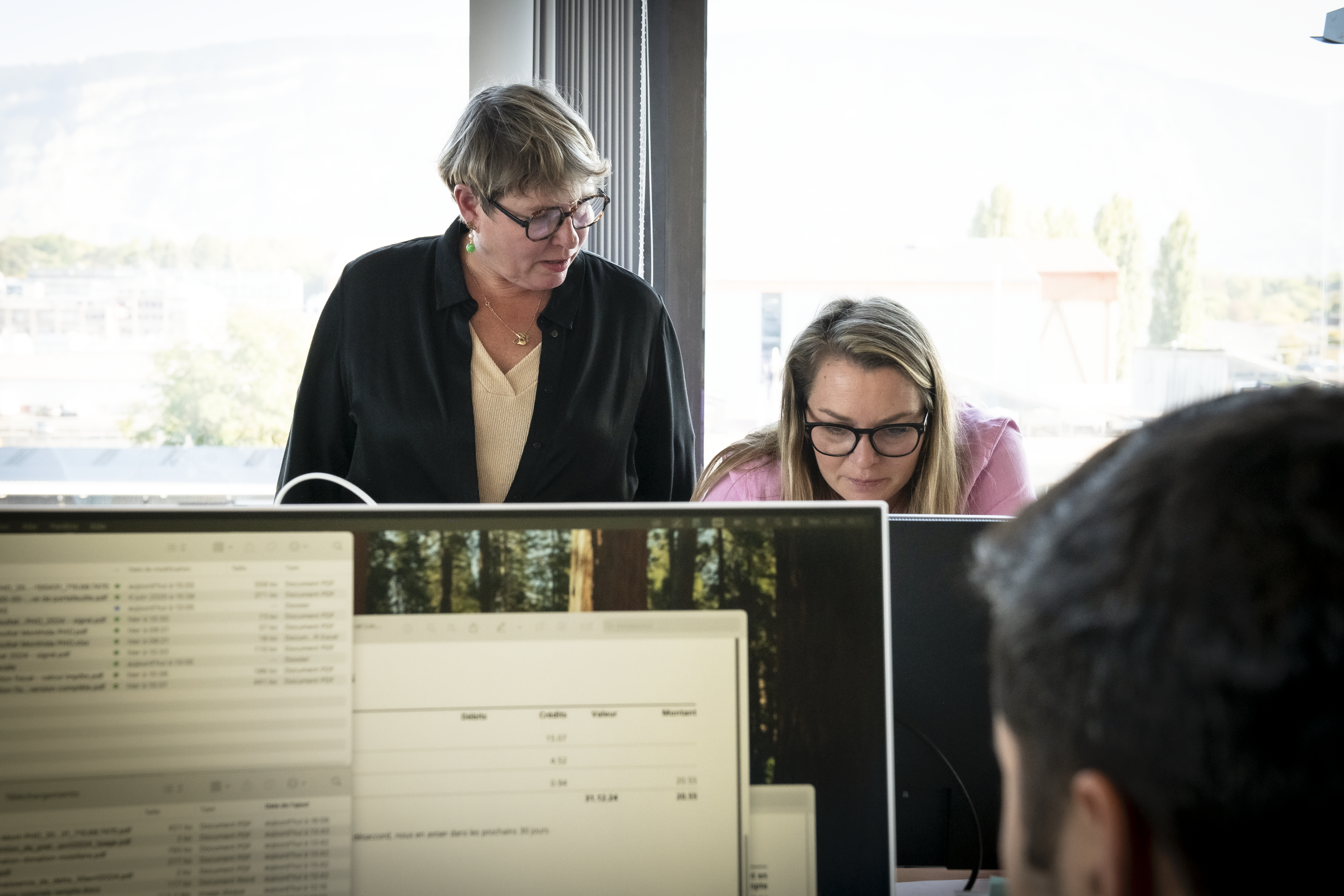 AB Consulting-16 black Android smartphone near ballpoint pen, tax withholding certificate on top of white folder